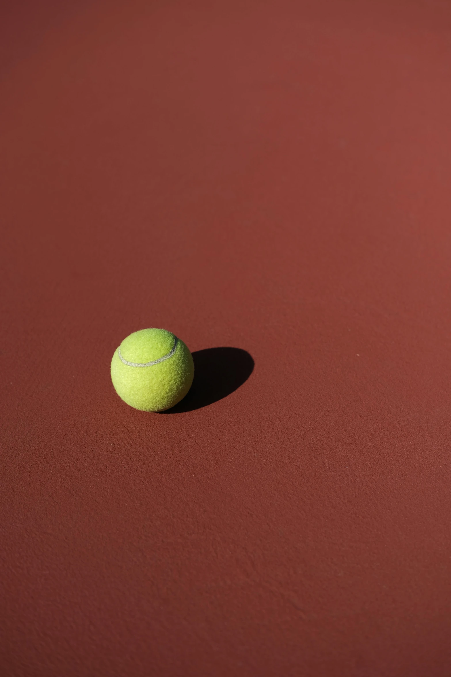 there is a tennis ball on the tennis court