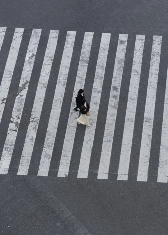 the man is walking alone behind him across the street