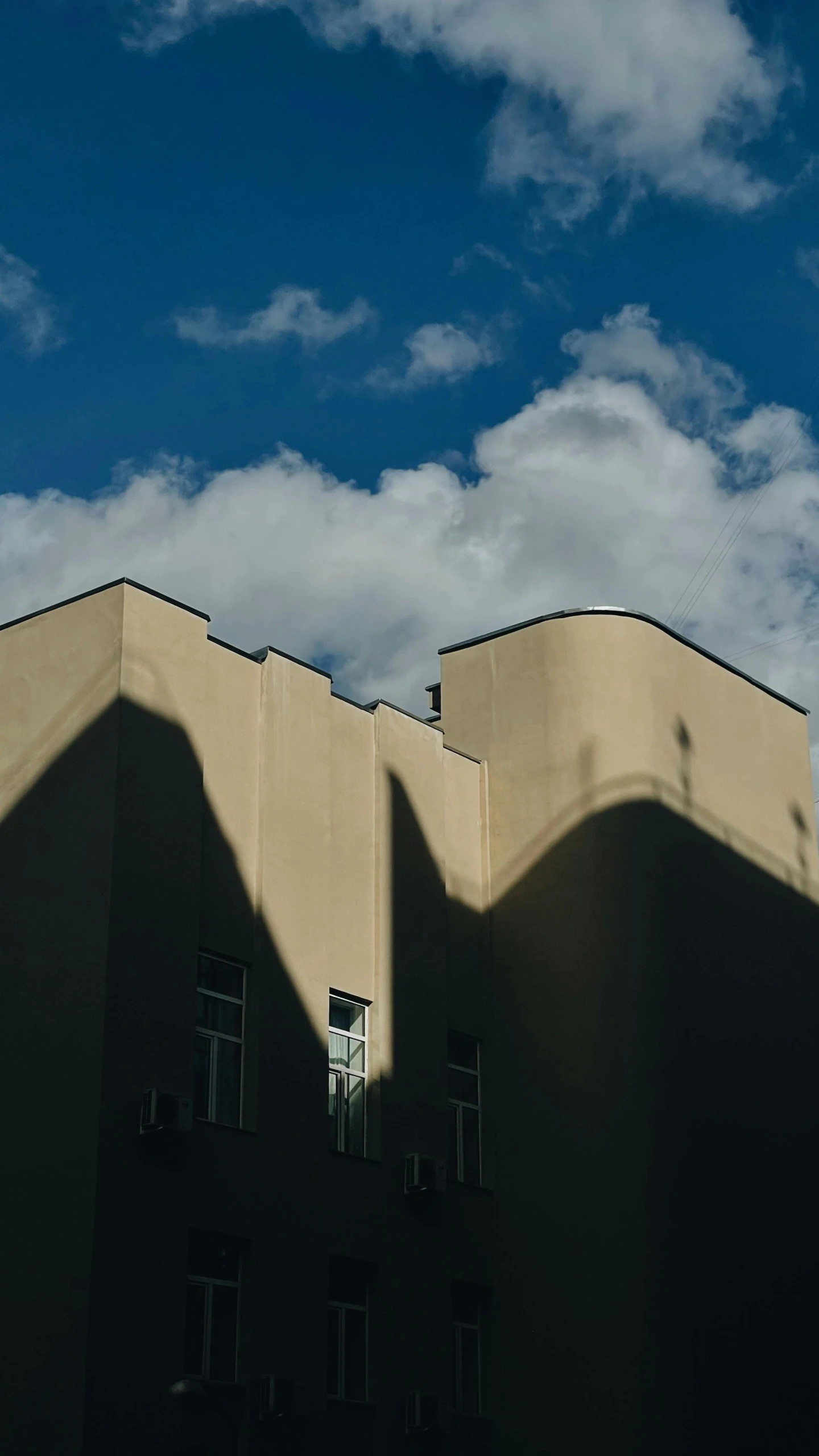 buildings with windows and clouds in the sky