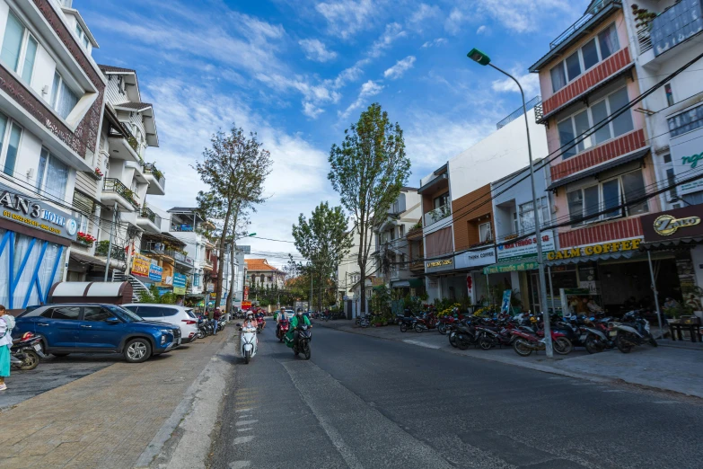 two motorcyclists are riding along the road in the daytime