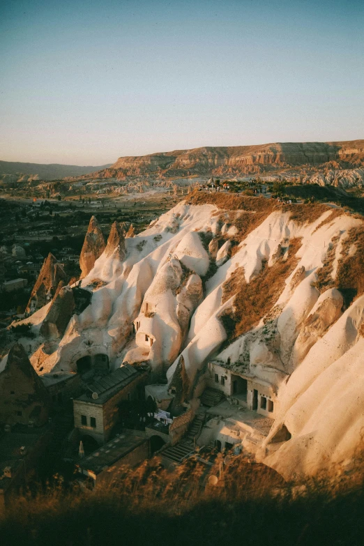 an aerial view of a building at the base of a mountain