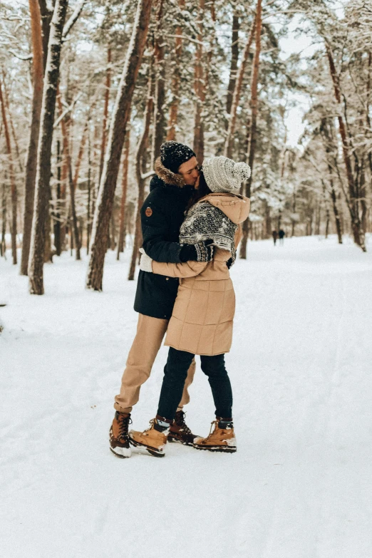 a couple are emcing in the snow