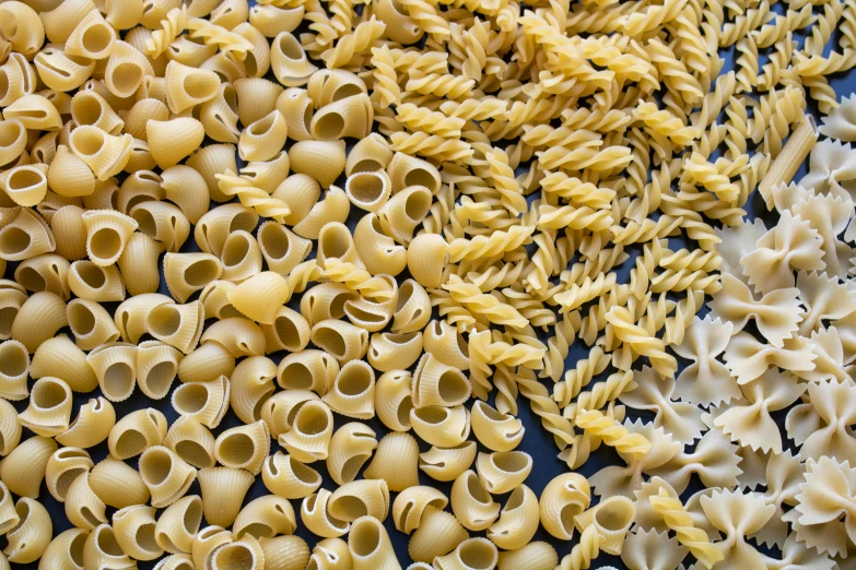 a blue table covered with lots of pasta shells