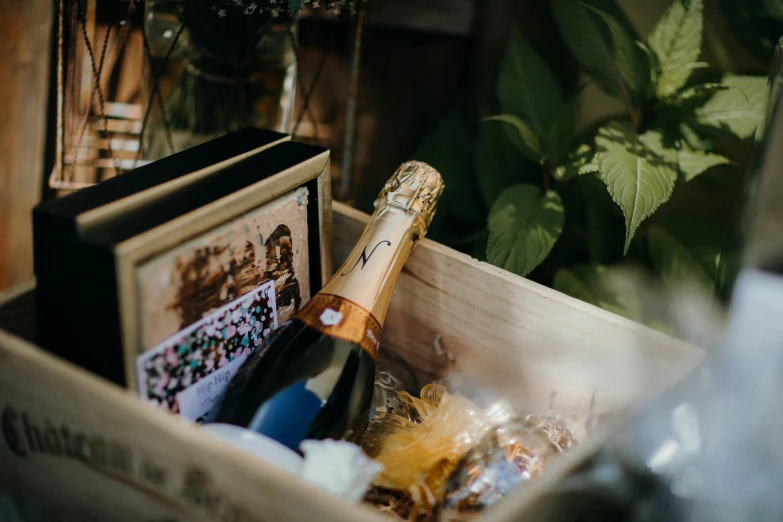 a bottle of wine sitting inside of a wooden container