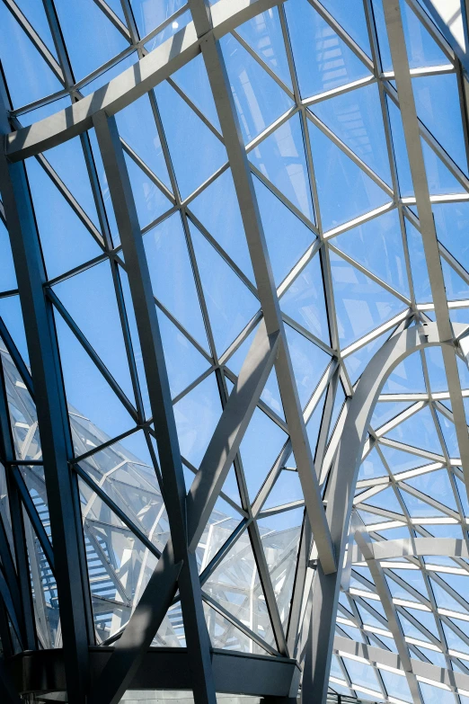 the top of a building with metal frame structure and blue sky in background