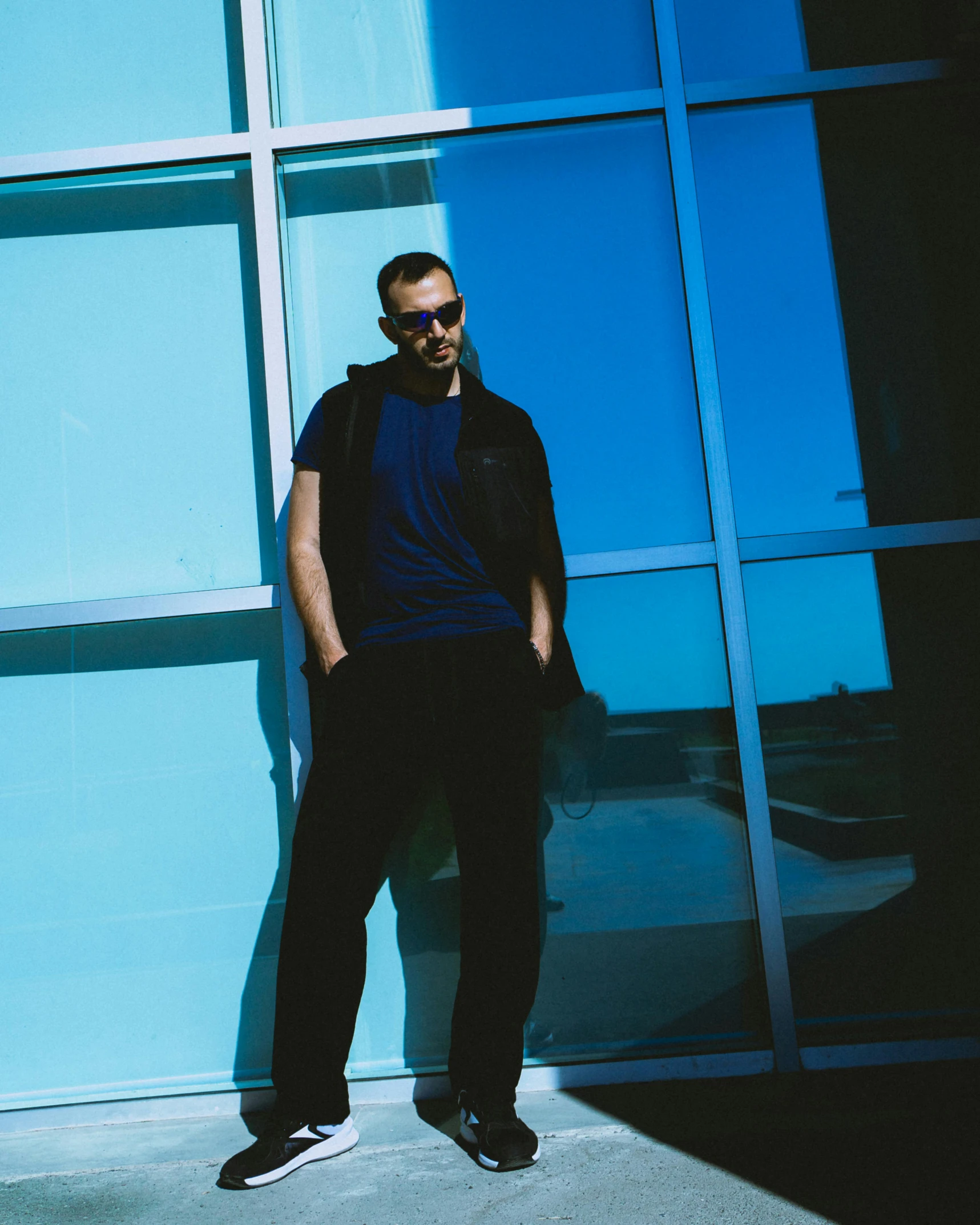 a man standing in front of a glass wall