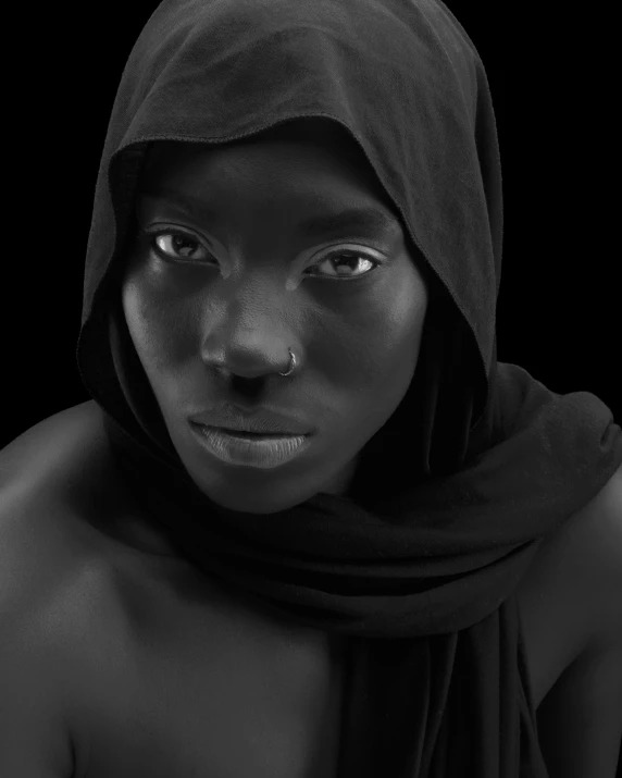 a person with black skin and a veil on their head