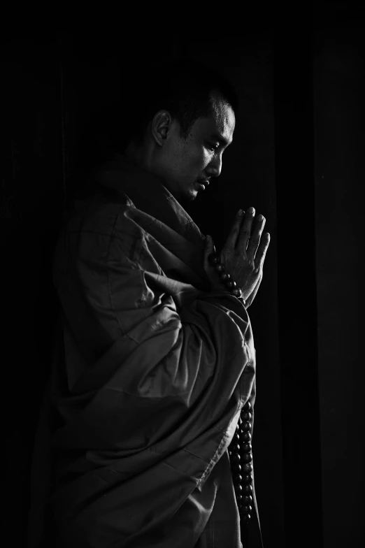 black and white po of man praying
