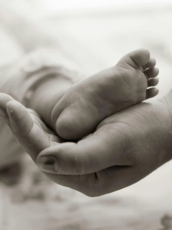 a baby that is laying down with its hand