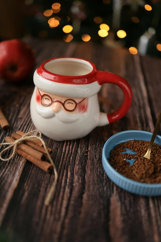 there is a coffee mug and a bowl of cinnamon