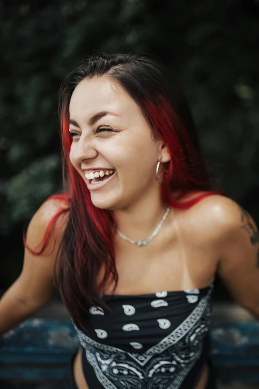 a women with red hair and piercings smiling