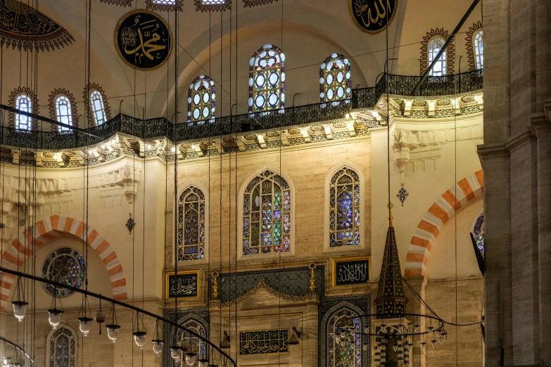 an ornate ceiling in a large building with stained glass windows