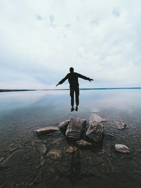 a man that is standing in the water