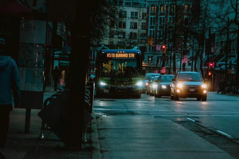 a double decker bus at night on a city street