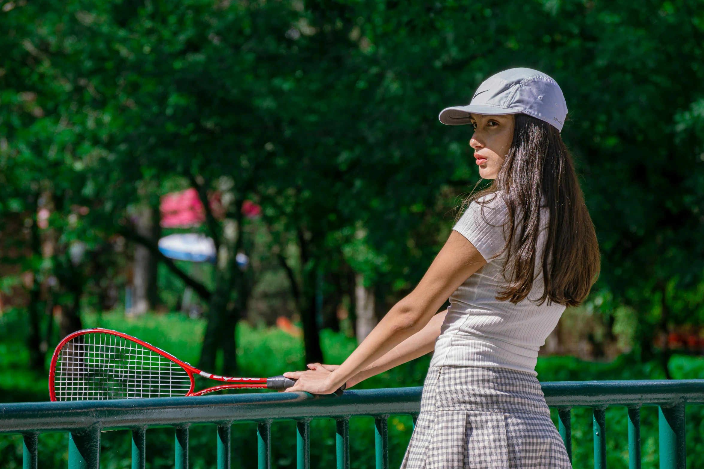 a young woman holding a tennis racquet in her hand