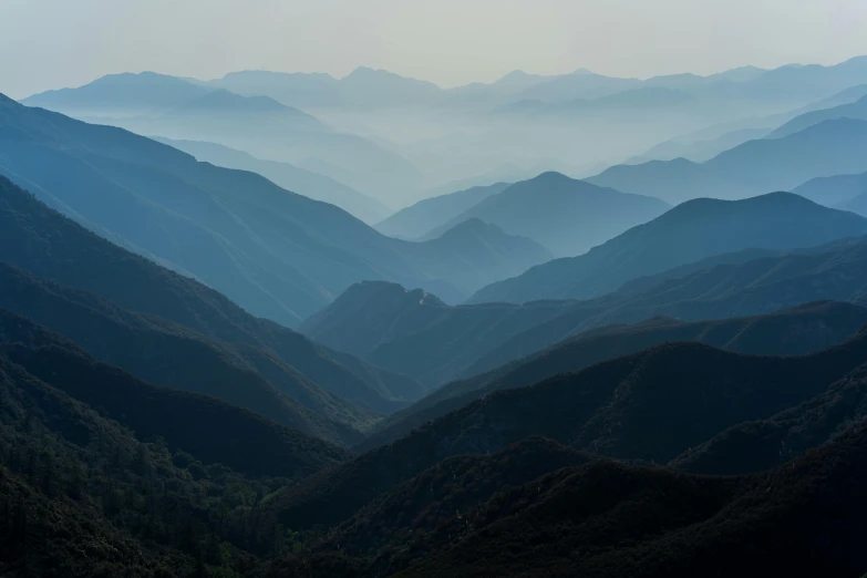 the view from top of a mountain in the distance