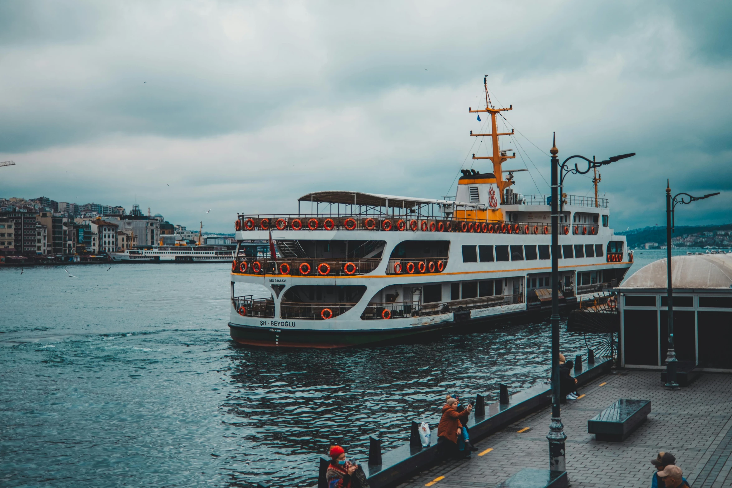 a boat traveling across the water in the rain