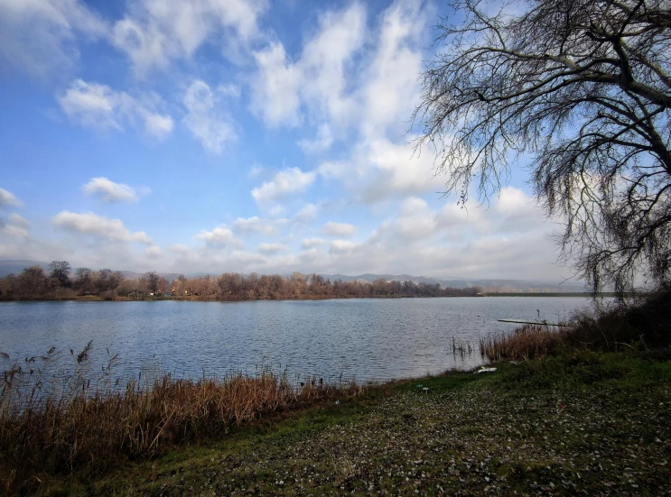 the sky is a very cloudy blue and there is still water