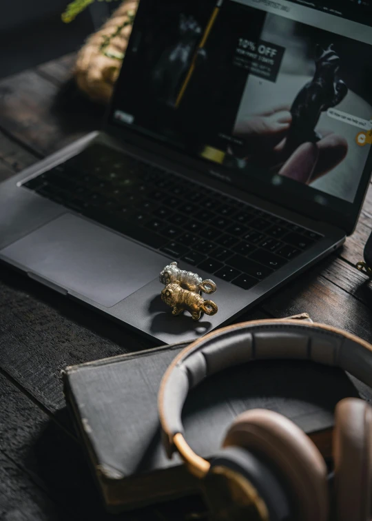 headphones are on a desk next to a laptop