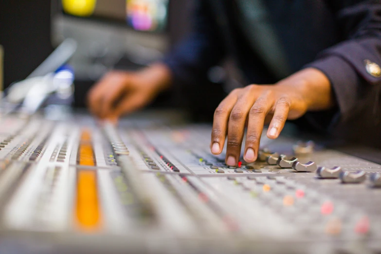 a person working on a soundboard using his hand