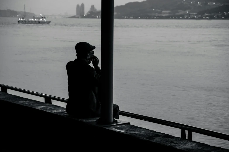 a person on the phone overlooking a body of water