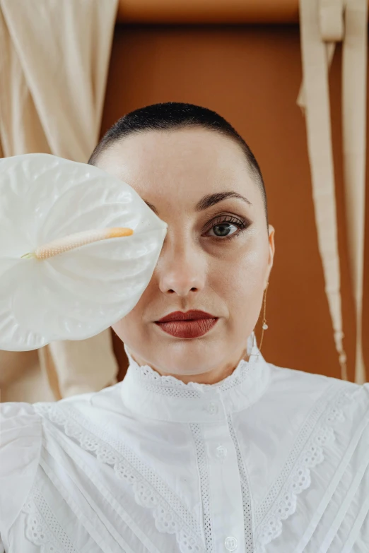 a woman wearing white blouse holding an umbrella