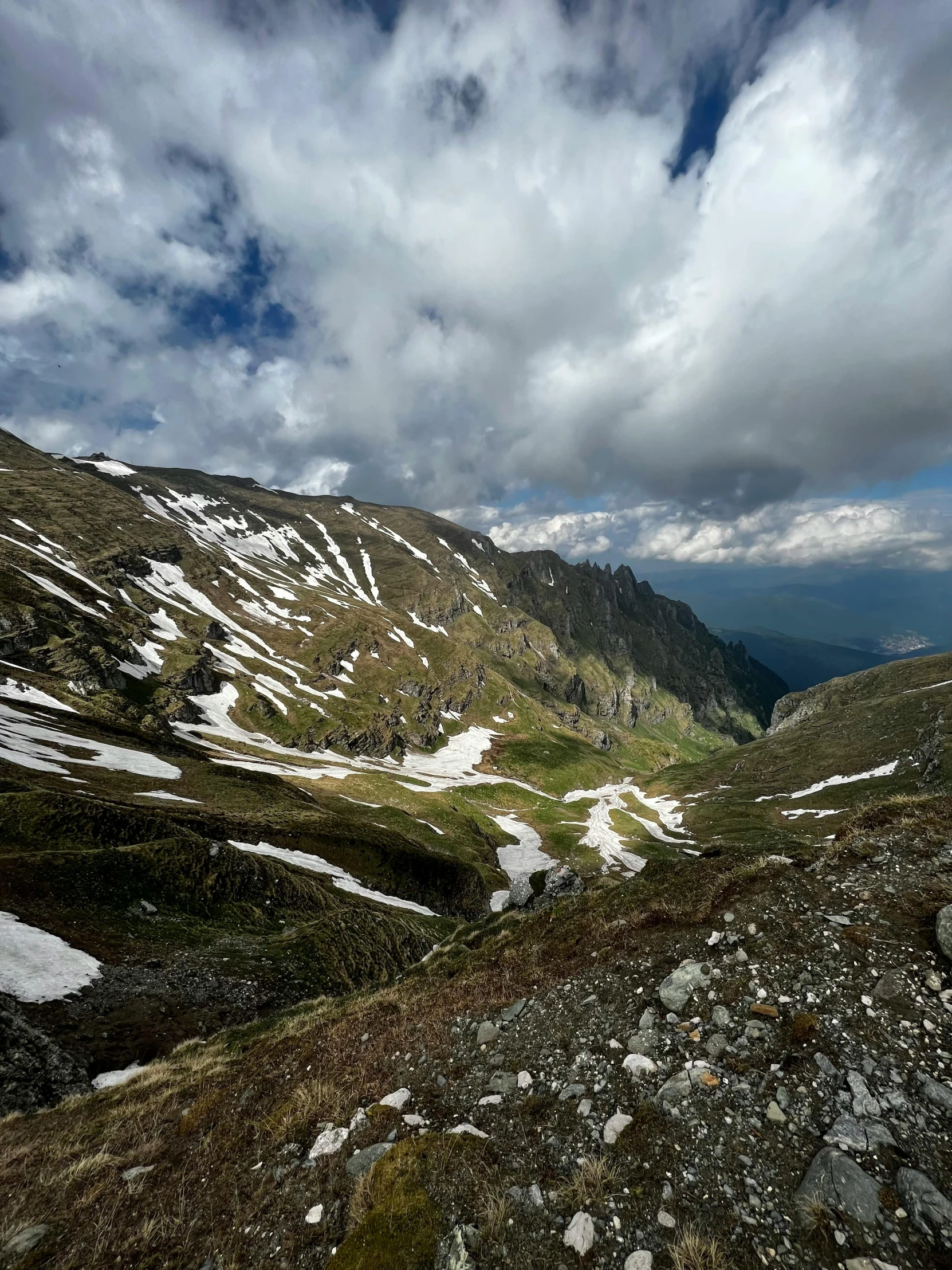 a mountain landscape with snow and rocky peaks