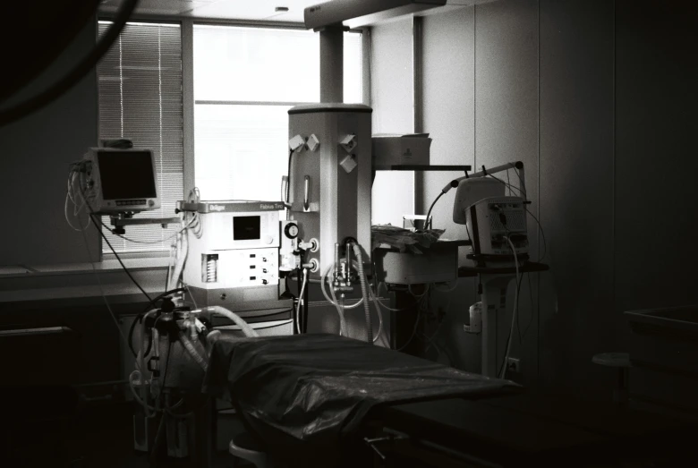 an old hospital room with several medical devices on a hospital bed