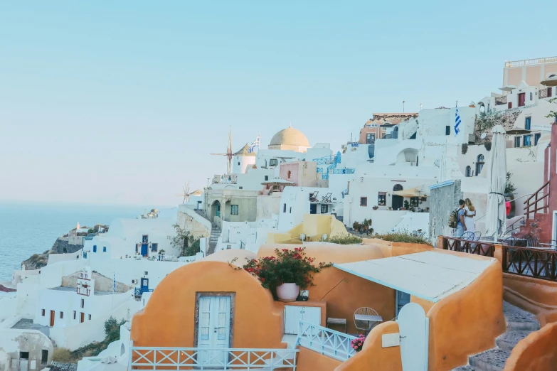 colorful houses line the side of a hillside near water