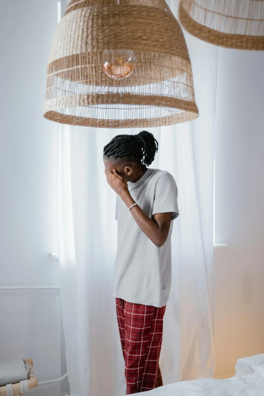 a woman standing in a room with some lamps