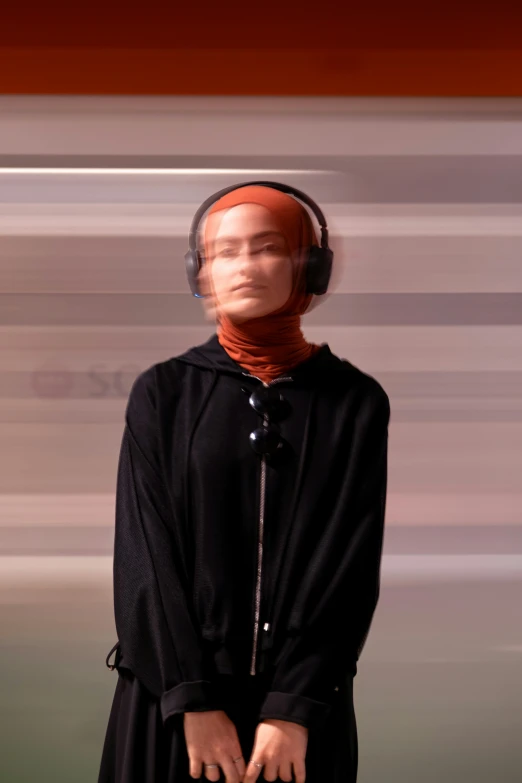 a mannequin wearing headphones and looking at a wall