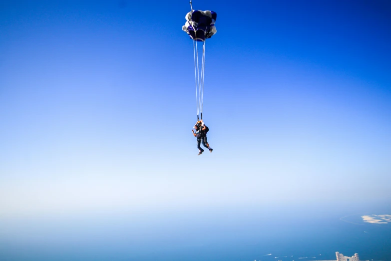 a parachutist is being held up by two parachutes