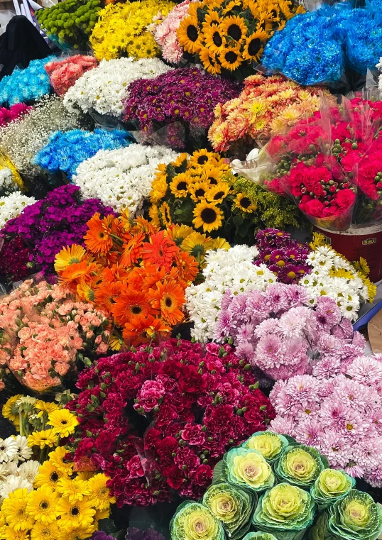 a huge pile of flowers in the middle of a road