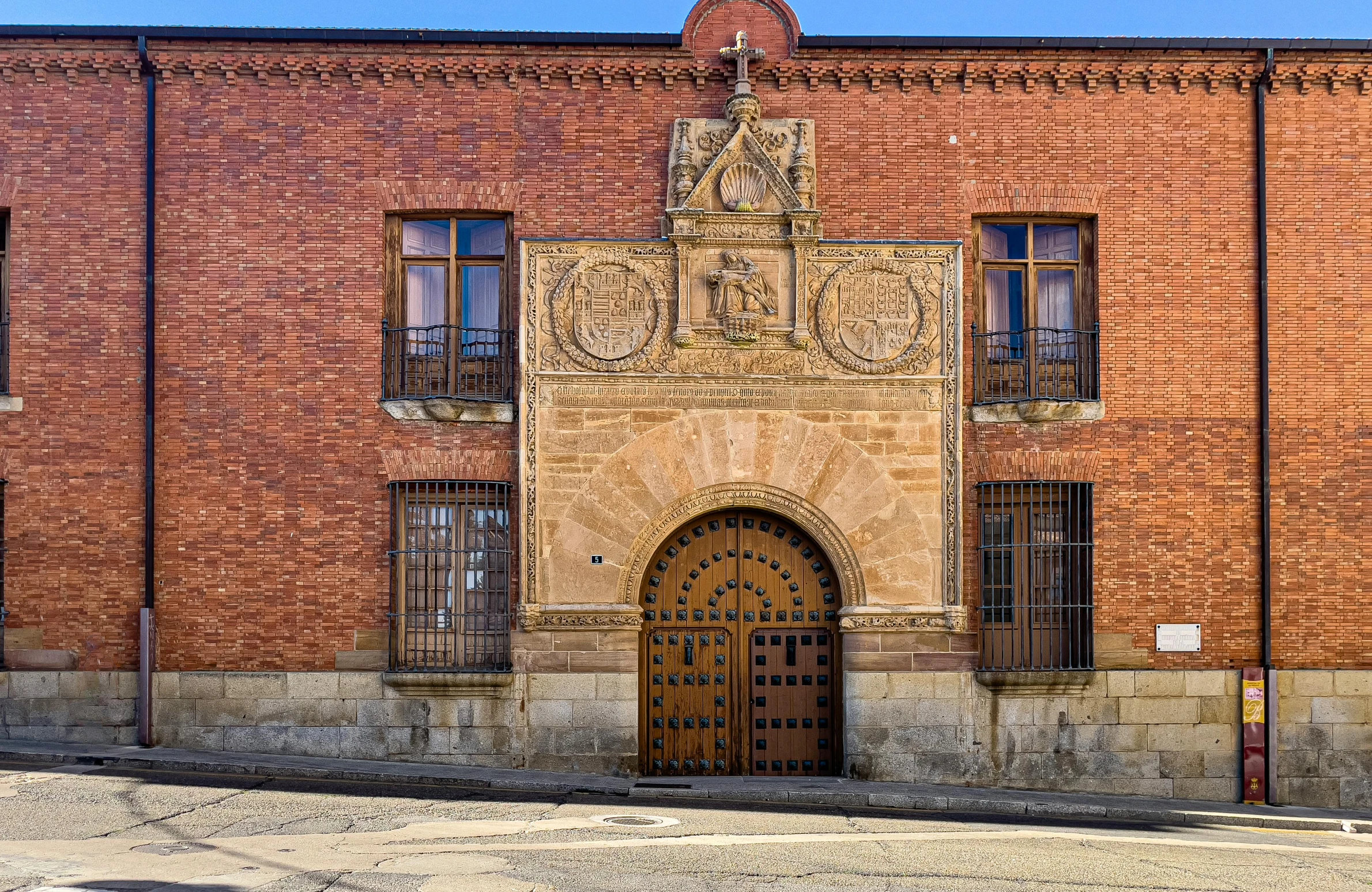 an old building with a brick building and a brown wooden door