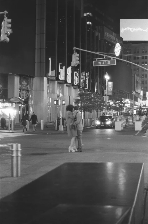 a couple of people are walking across a street