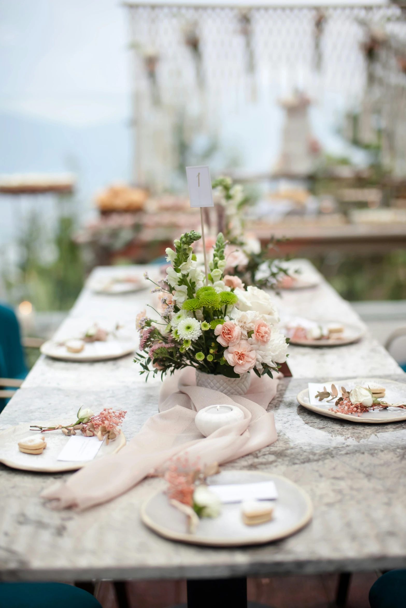 table with white plates and flowers on it