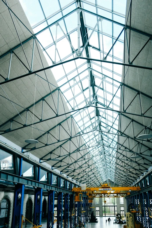 the interior of a warehouse with a glass ceiling and steel beams