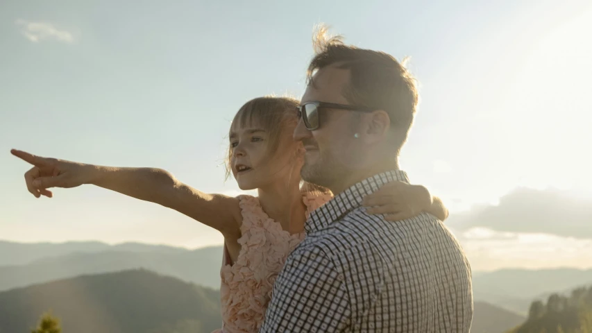 a young man with a young woman holding each other's shoulders