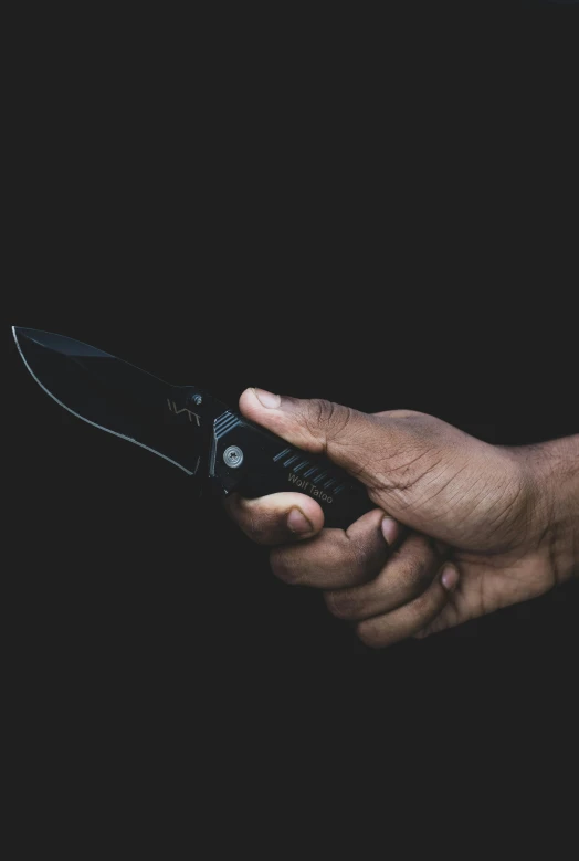 a person holds onto an open knife