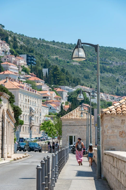 a small narrow, paved road near some buildings