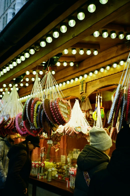 people at a market looking at things hanging up