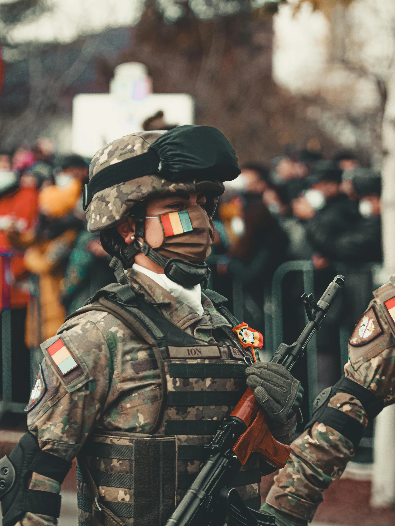 an armed man holding an akur rifle in his hands