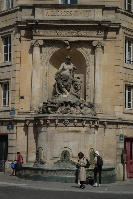 a fountain with some people standing in front of it