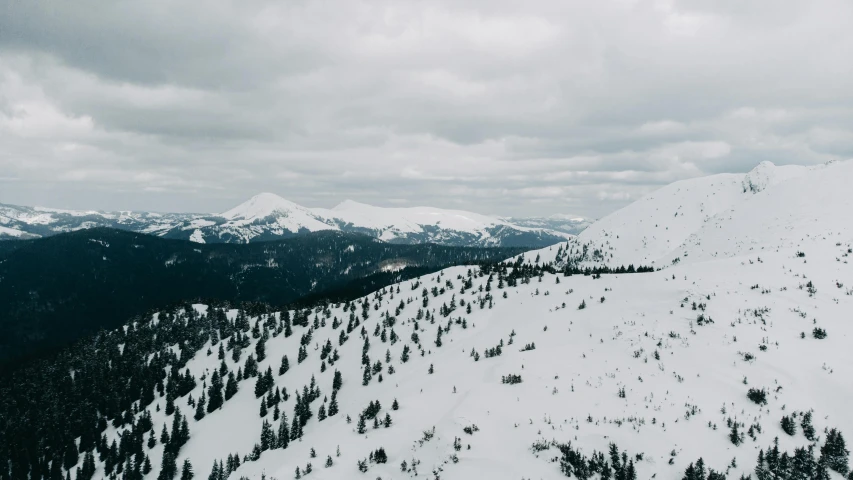 a man riding skis down the side of a snow covered mountain