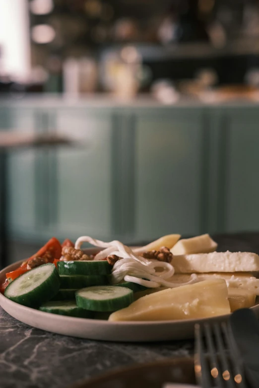 a plate with some sliced cucumbers and pasta on it