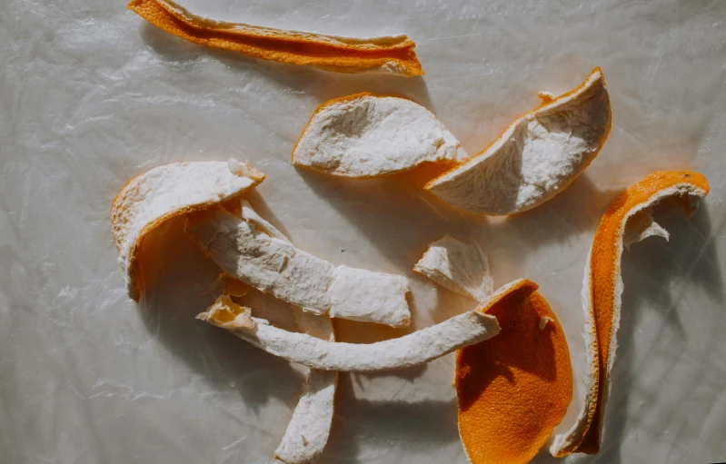 peeled orange peels laying on white surface