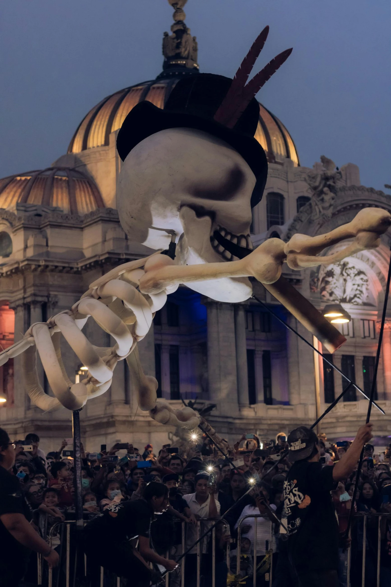a skeleton flying over a crowd in front of a building