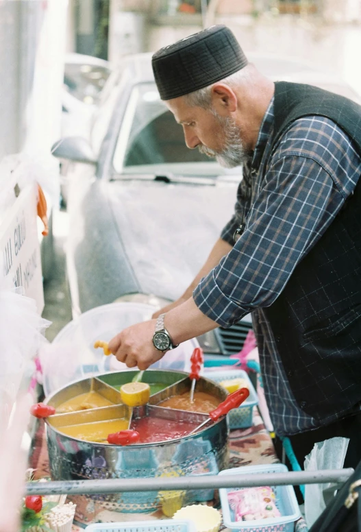 an old man selling food at a vendor