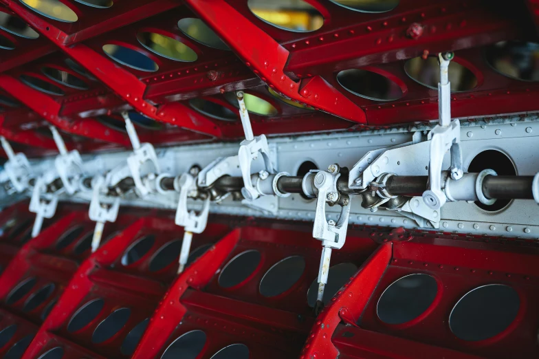 some metal parts on the red stand are attached to a metal object