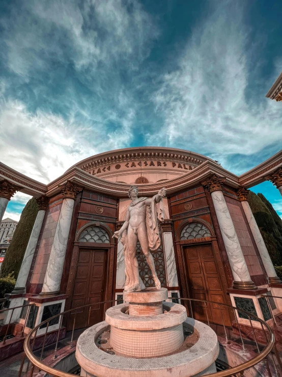 a statue stands next to the entrance to a building